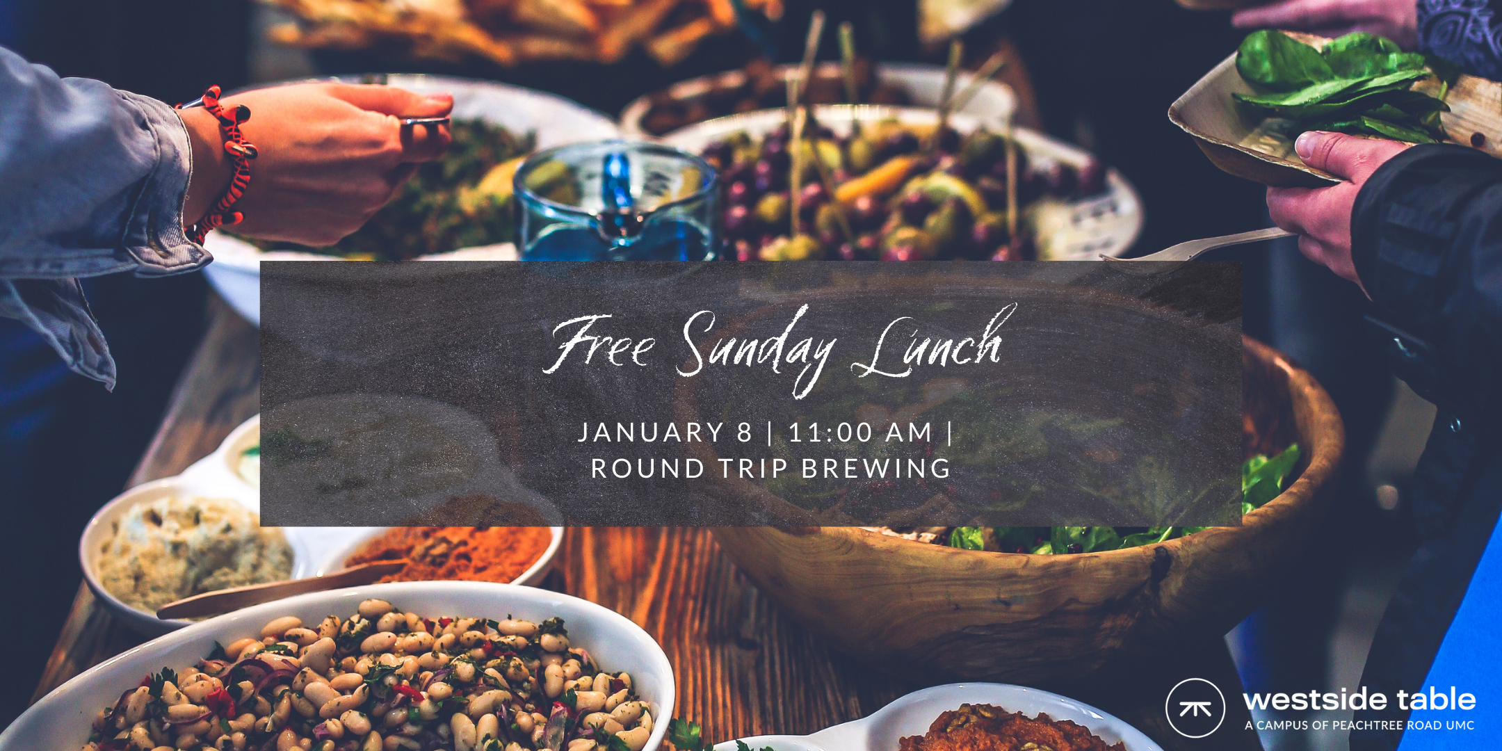 Image text says "Free Sunday Lunch: January 8th, 11am, Round Trip Brewing." The text is written in white chalk and the background image shows a potluck scene with platters and bowls of food.
